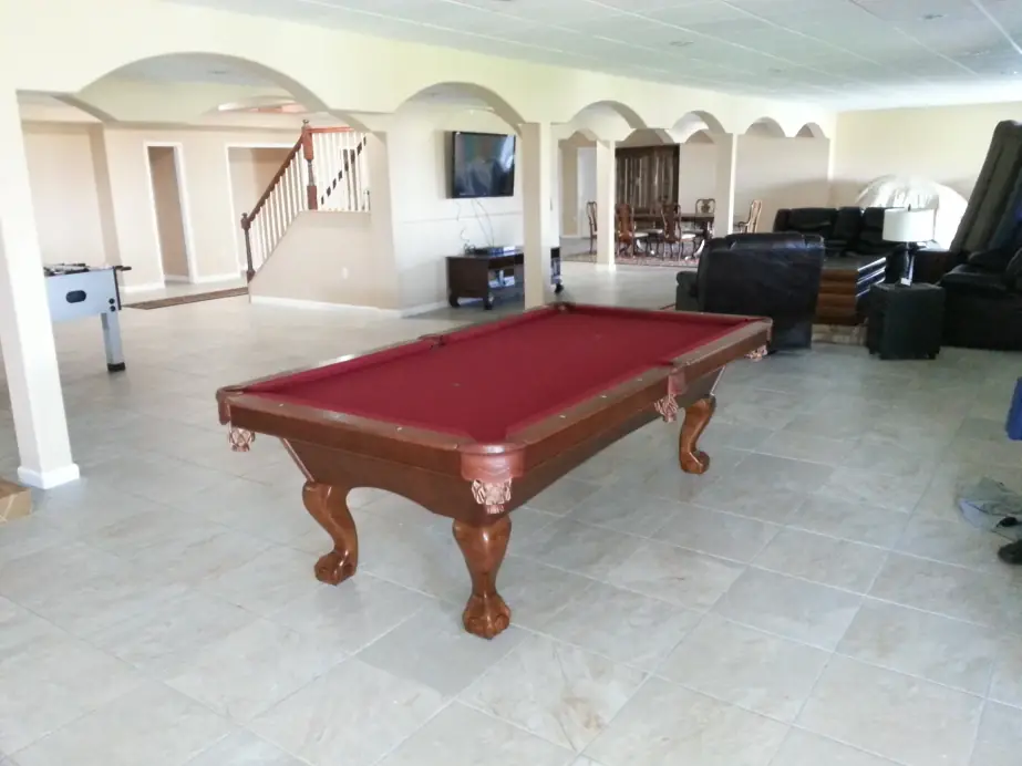 A burgundy felt table with ball-and-claw legs in a wide open great room